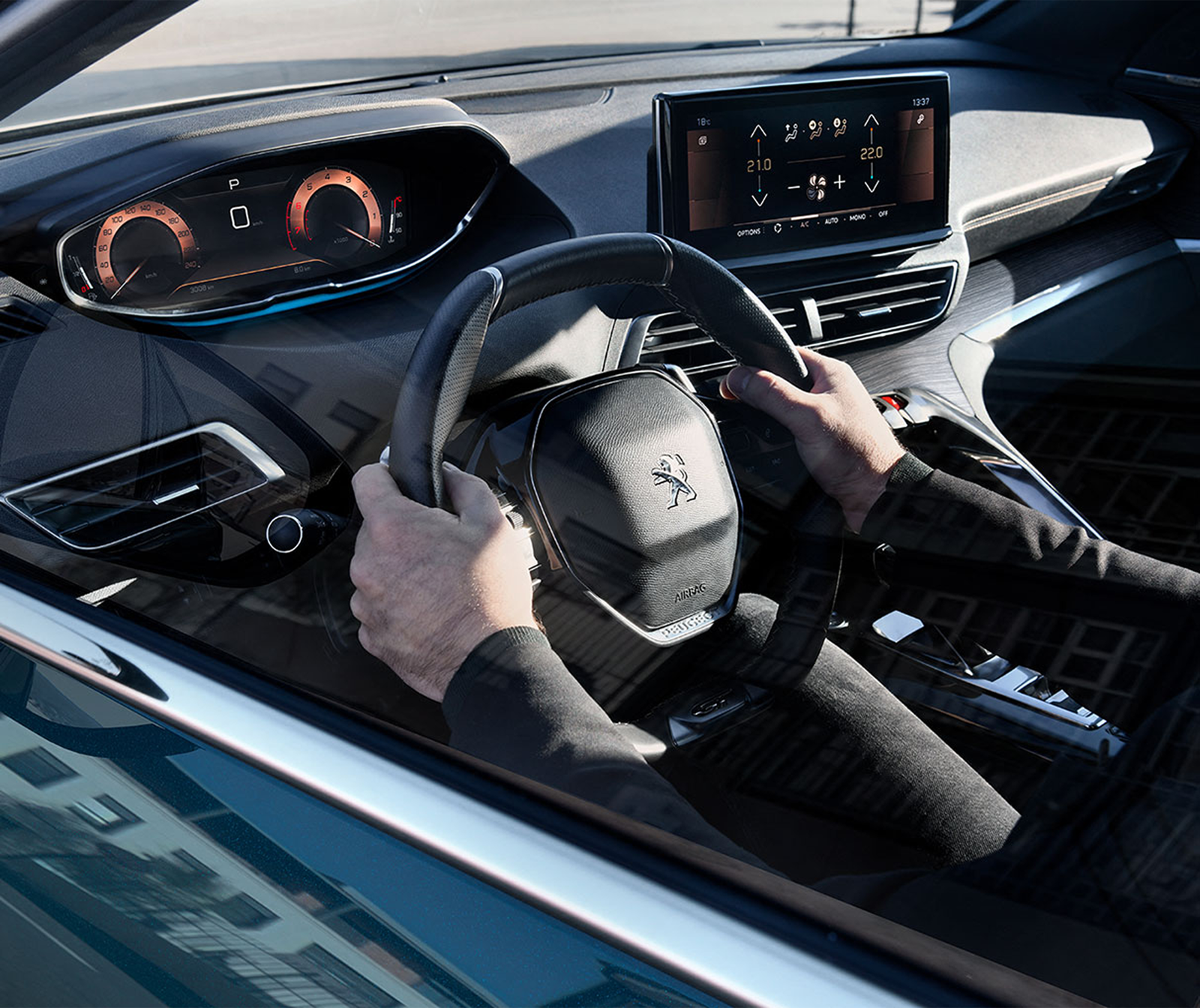 Peugeot i-Cockpit: a small steering wheel below a raised digital cluster and center touchscreen